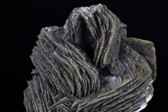 Calcite with boulangerite — upper macro view showing curved blade formation and layered crystal growth around central cavity