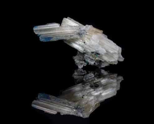 Cerussite and Rosasite — Minerals Photography Cerussite and rosasite mineral specimen — full view on black mirror background showing prismatic cerussite crystals with blue rosasite patches, macro photography by Minerals Photography